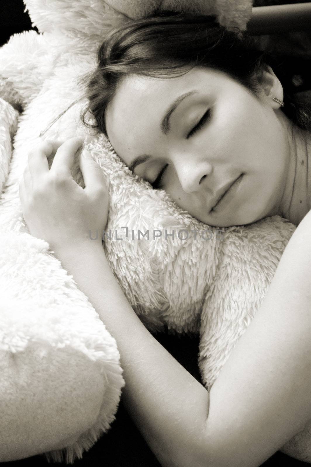 Beautiful girl sleeping on soft pillow in sepia