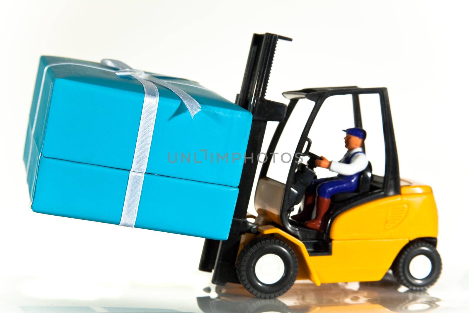 A toy forklift truck delivering a wrapped present