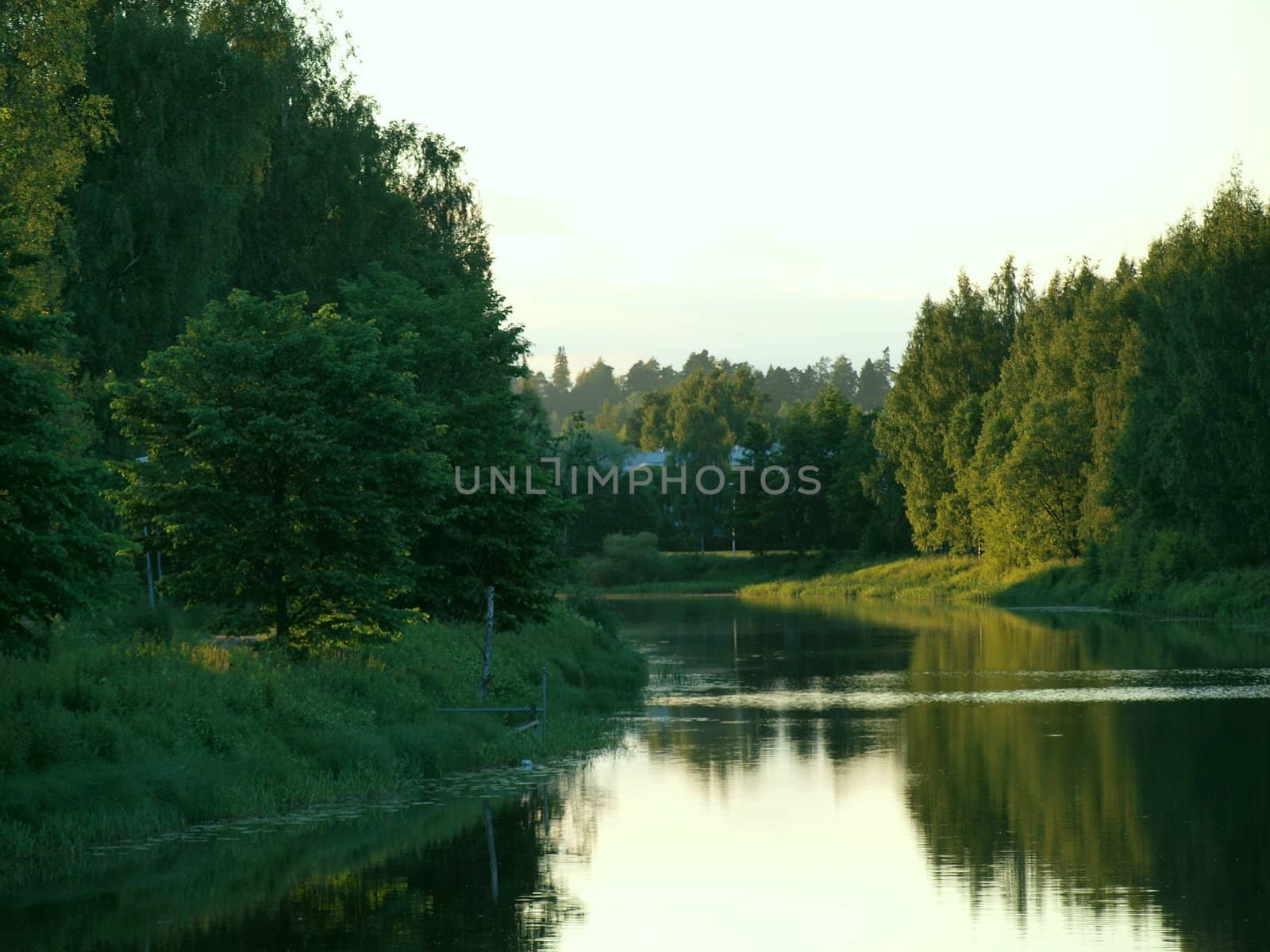 Calm river flowing in summer evening