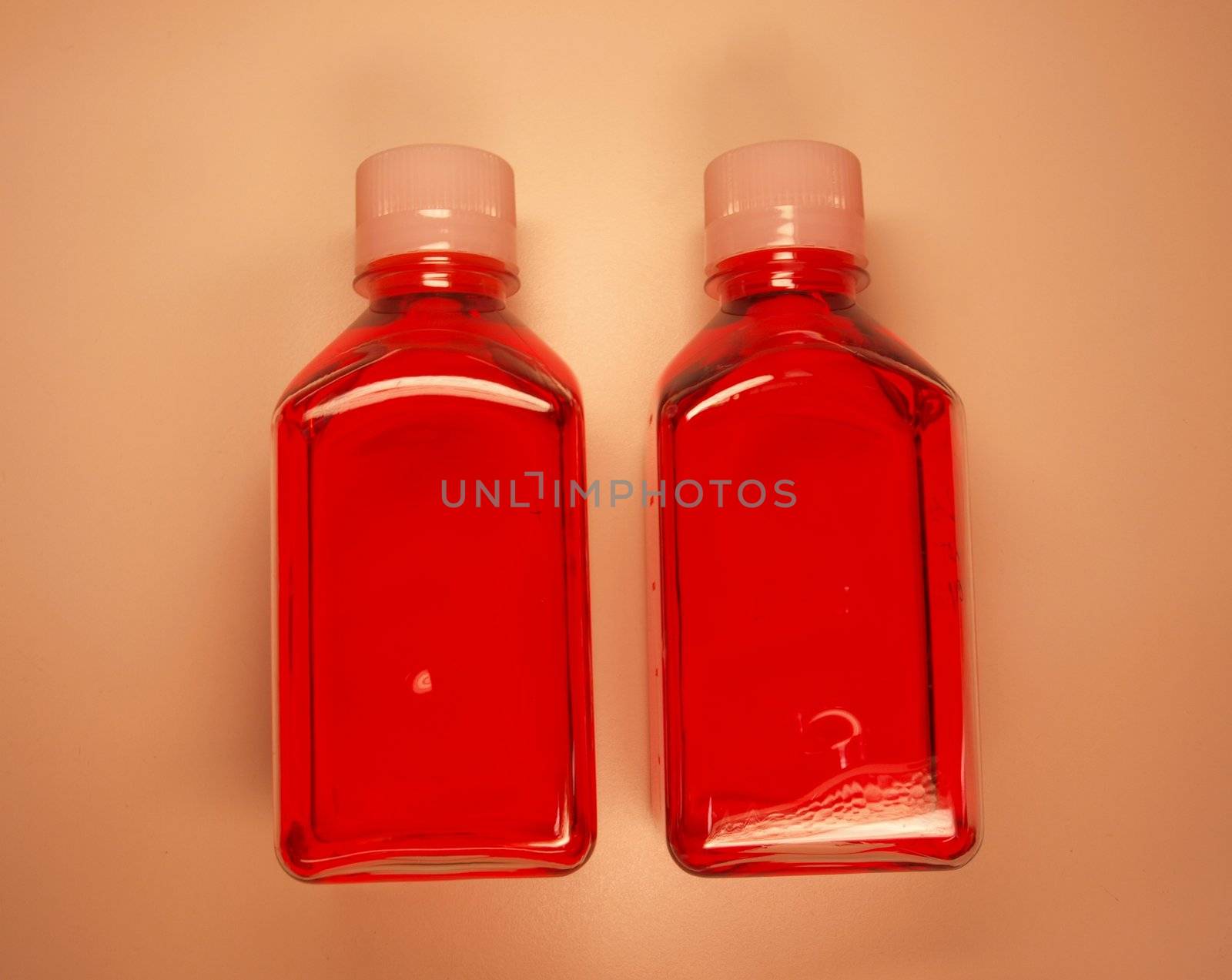 Flasks with a red liquid cell growth medium used in laboratory research
