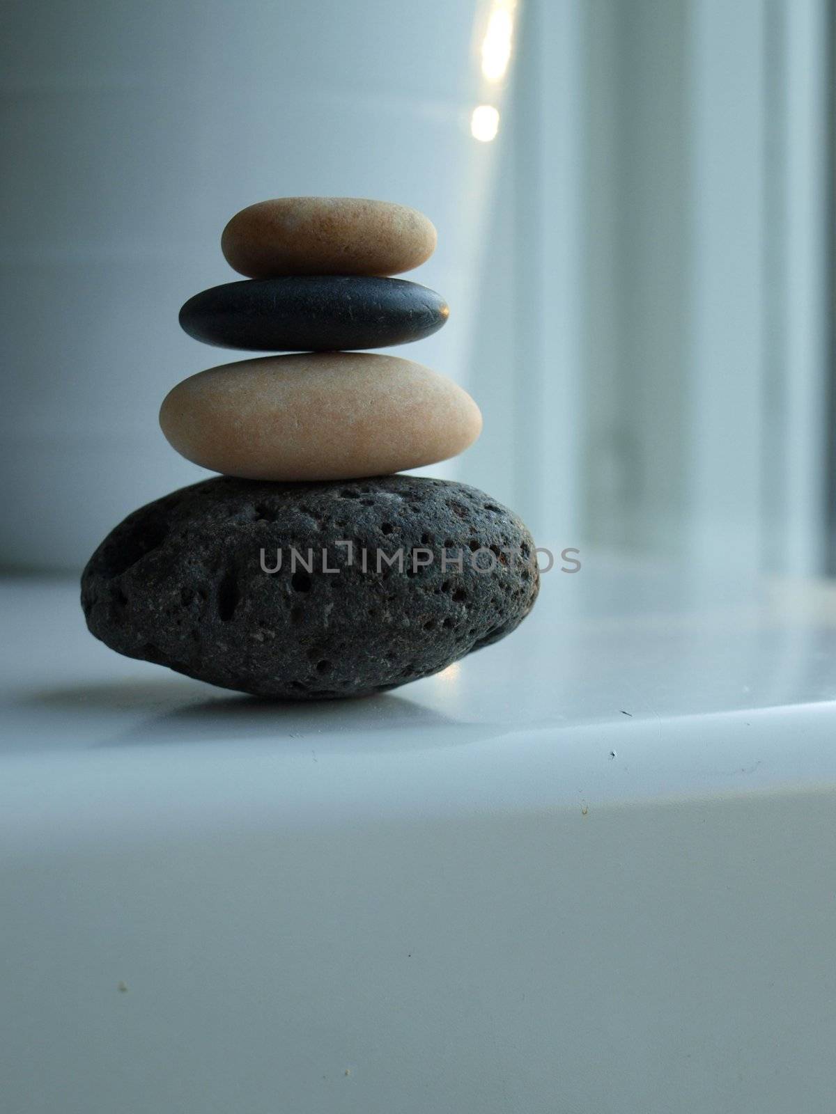 A tower of black and white stones on white background