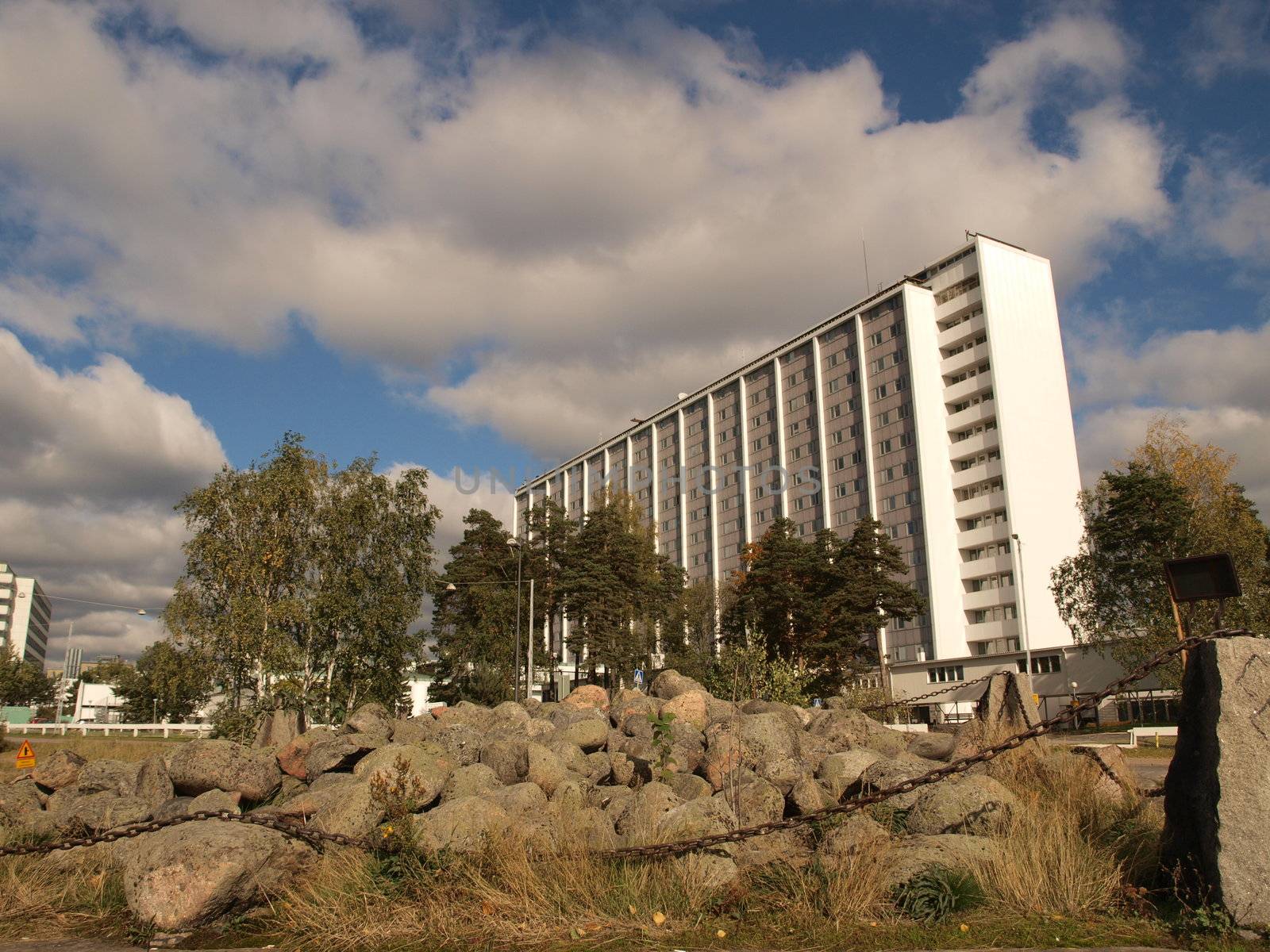 Ancient viking grave in front and modern hospital building in the background