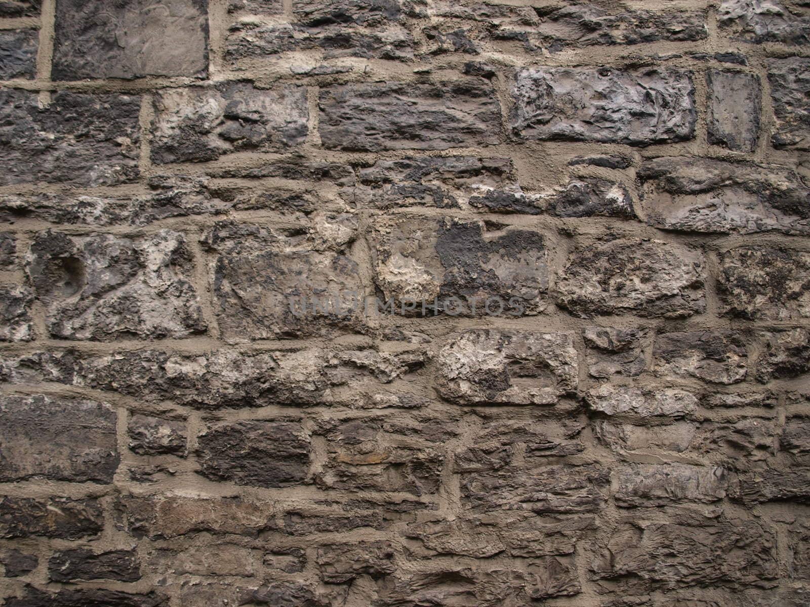 Wall of different sized bricks for texture background