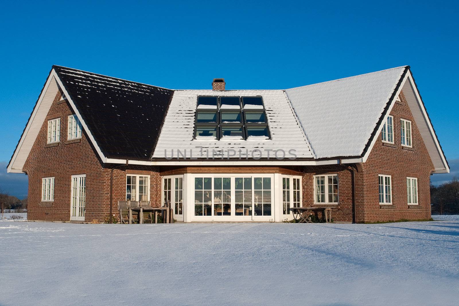 Beautiful modern design house home in winter covered with snow