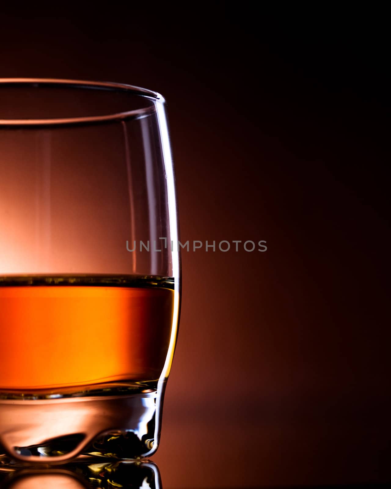 glass filled with drink, amber light