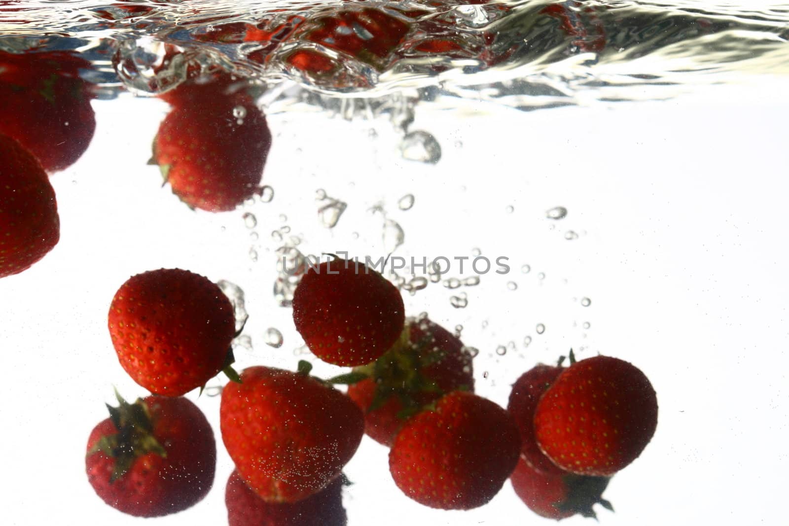 strawberry splash in water isolated on white background