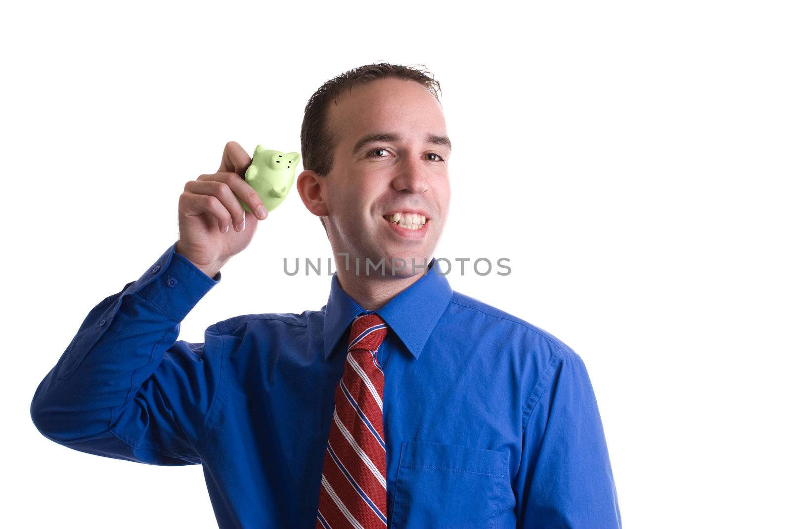 Concept image of "money talks" featuring a businessman shaking his piggy bank and listening to the sound of his money