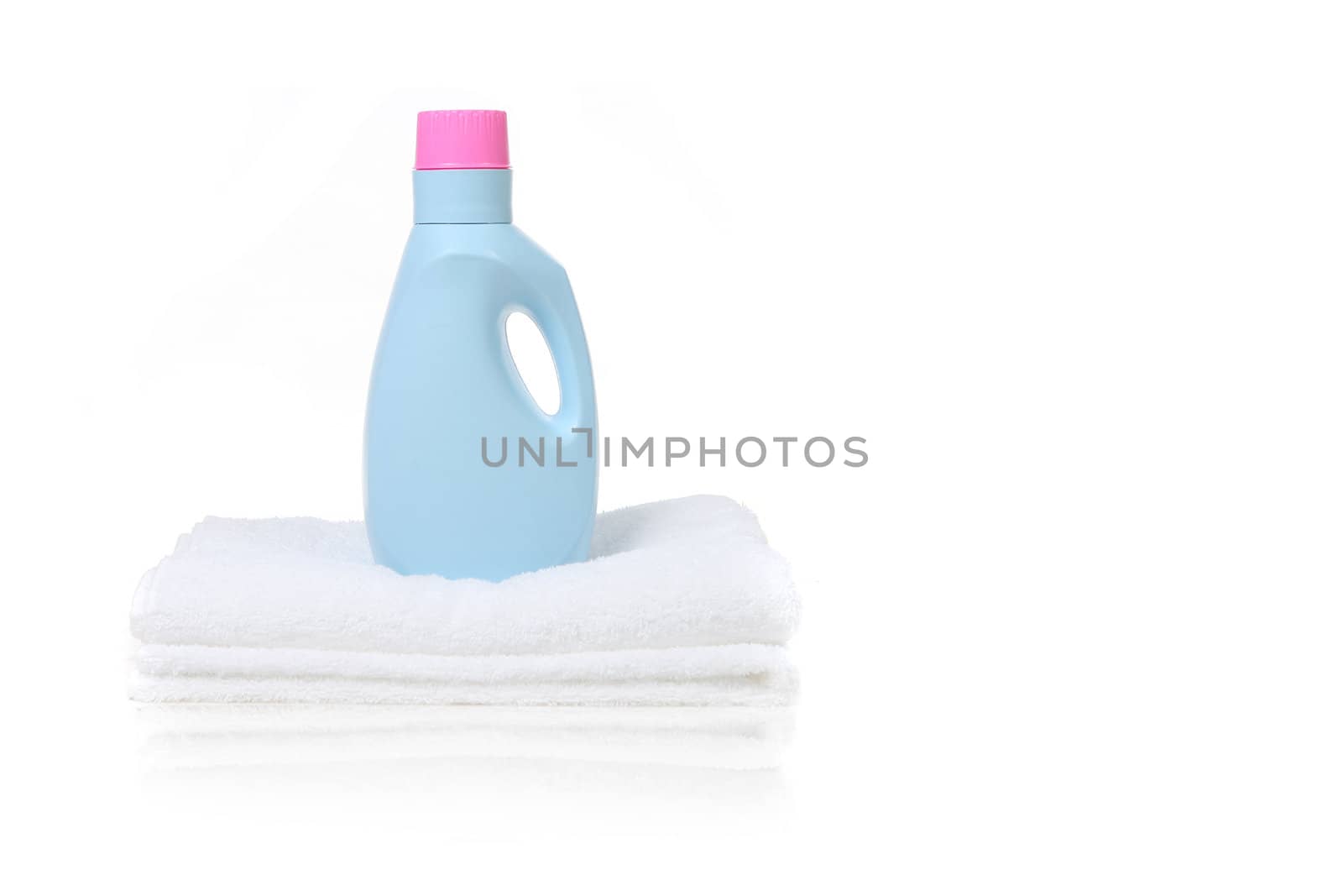Fabric Softener Detergent Container Sitting on a White Folded Towel With Copy Space