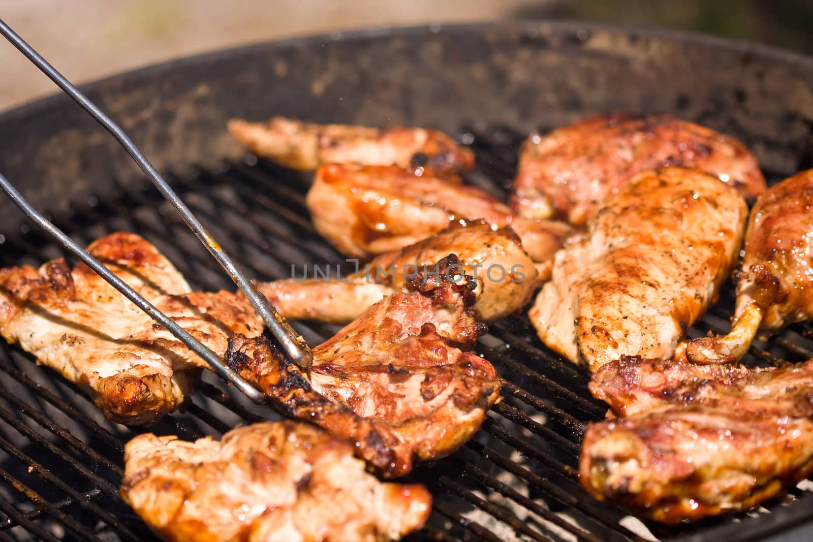 barbecue chicken on the grill with sauce