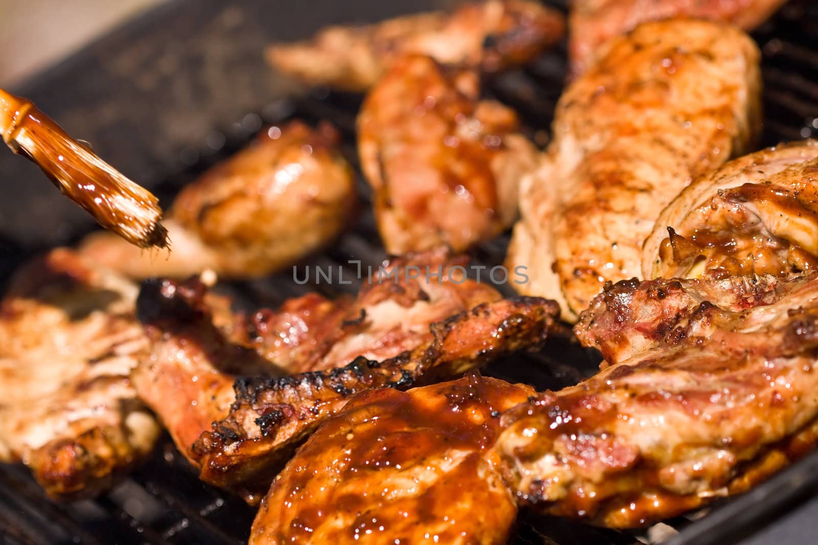 barbecue chicken on the grill with sauce