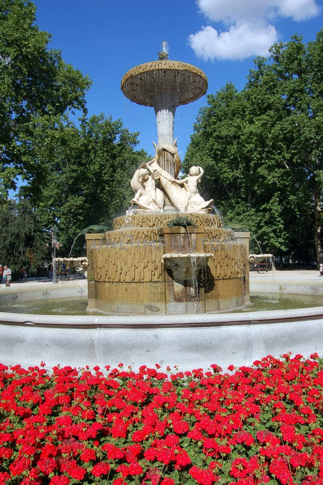 Fountain in Retiro's Park with red flowers, Madrid
