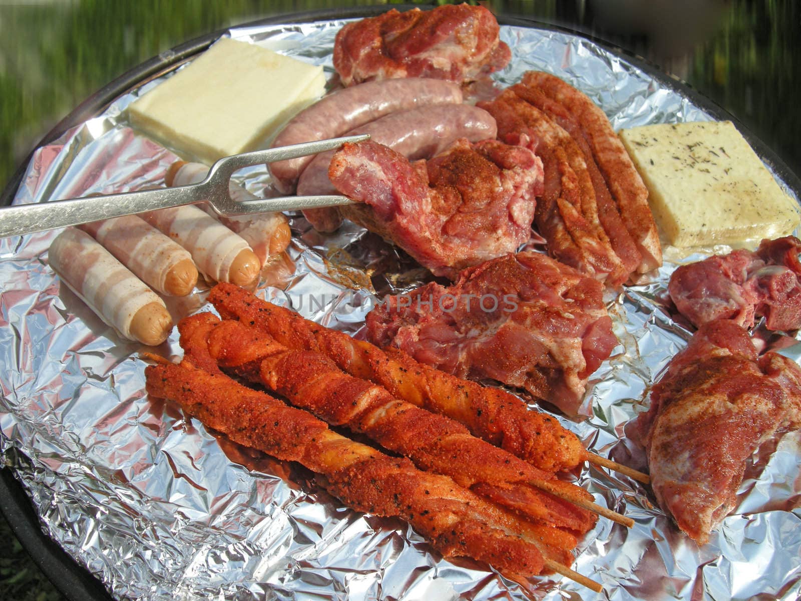 Seasoned strip steaks on a grill ready for cooking