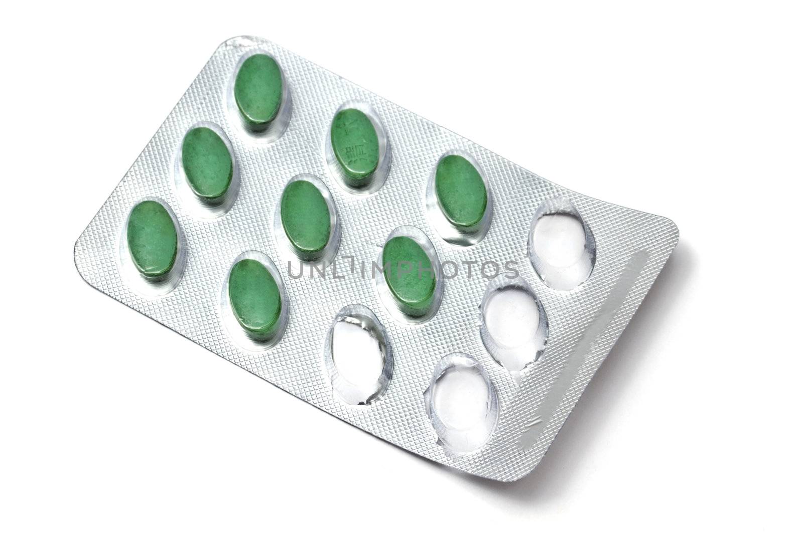 green pills isolated on white background 
