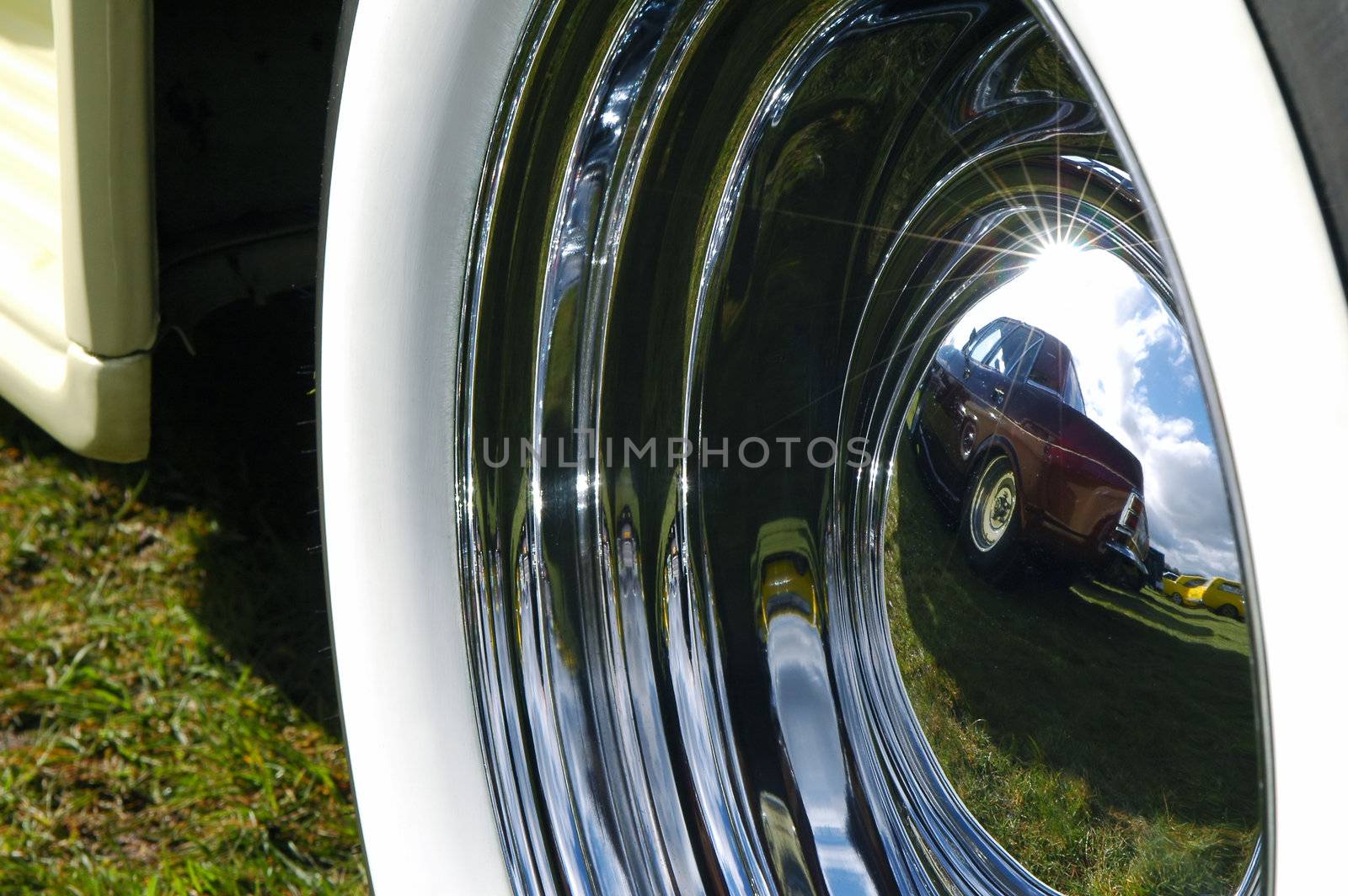 colorful reflections off the wheel hub of a vintage car