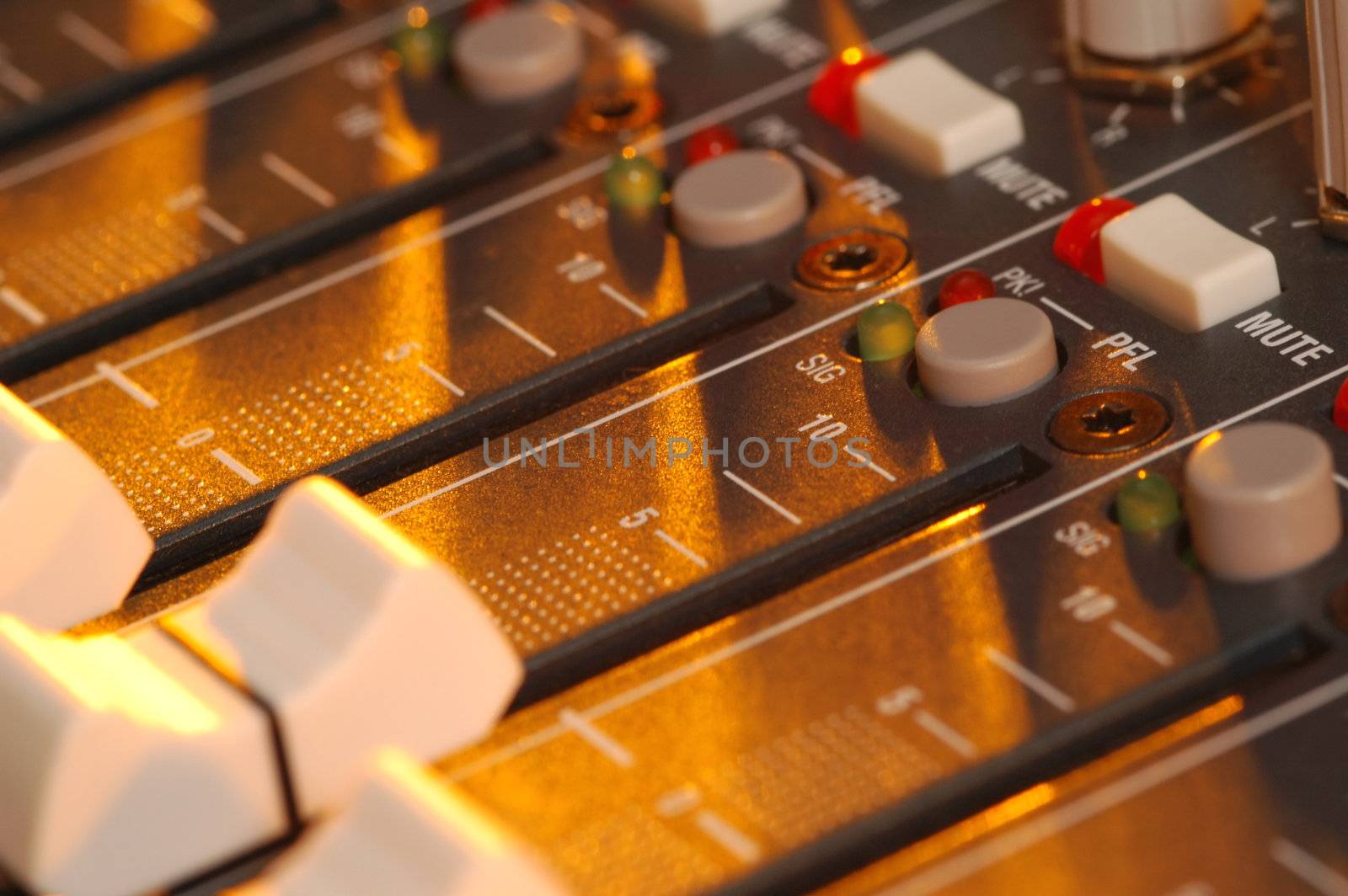 golden light falling across mixing soundboard