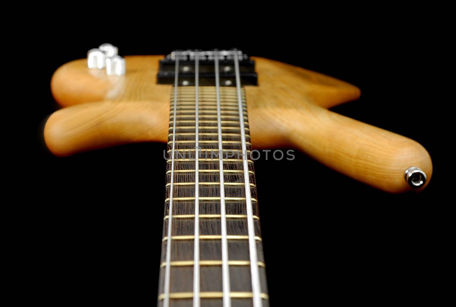 view down the neck of a four string bass guitar