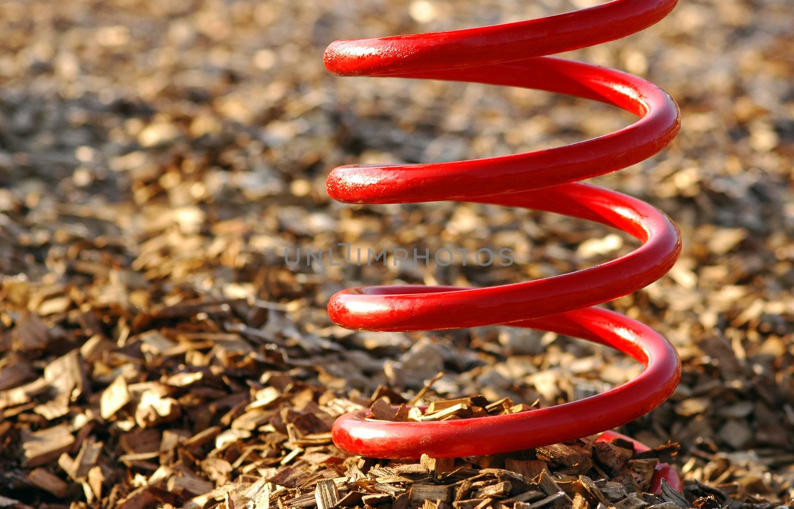 abstract of a big red spring on a wood chip base