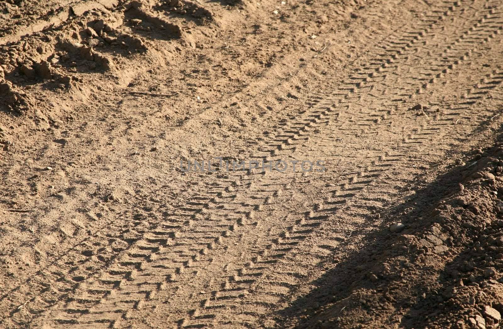 Dirt background with vehicle pattern track