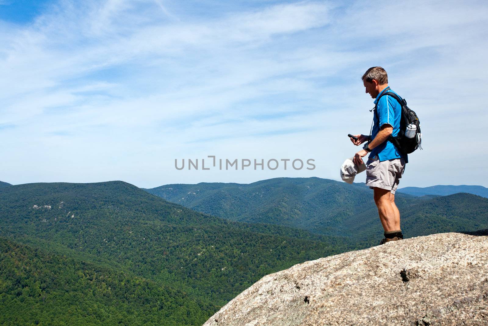 Asian hiker looks over valley in the Shenandoah on a climb of Old Rag