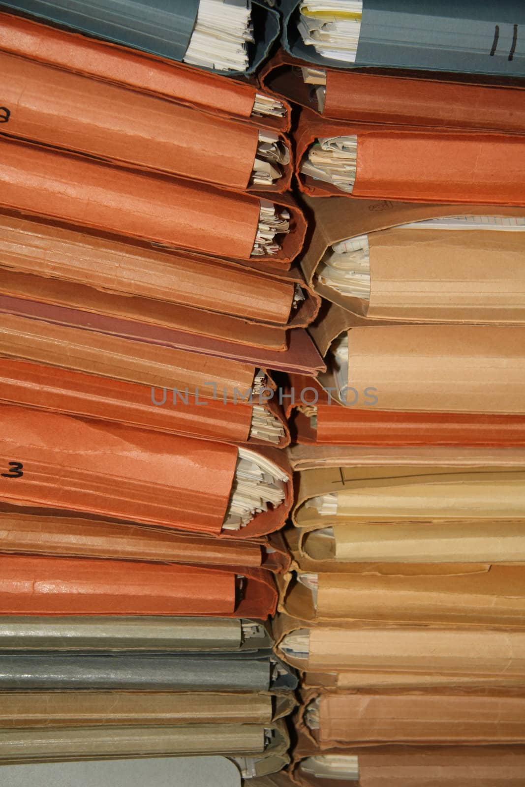 Stack of cardboard dossiers in many different colors 