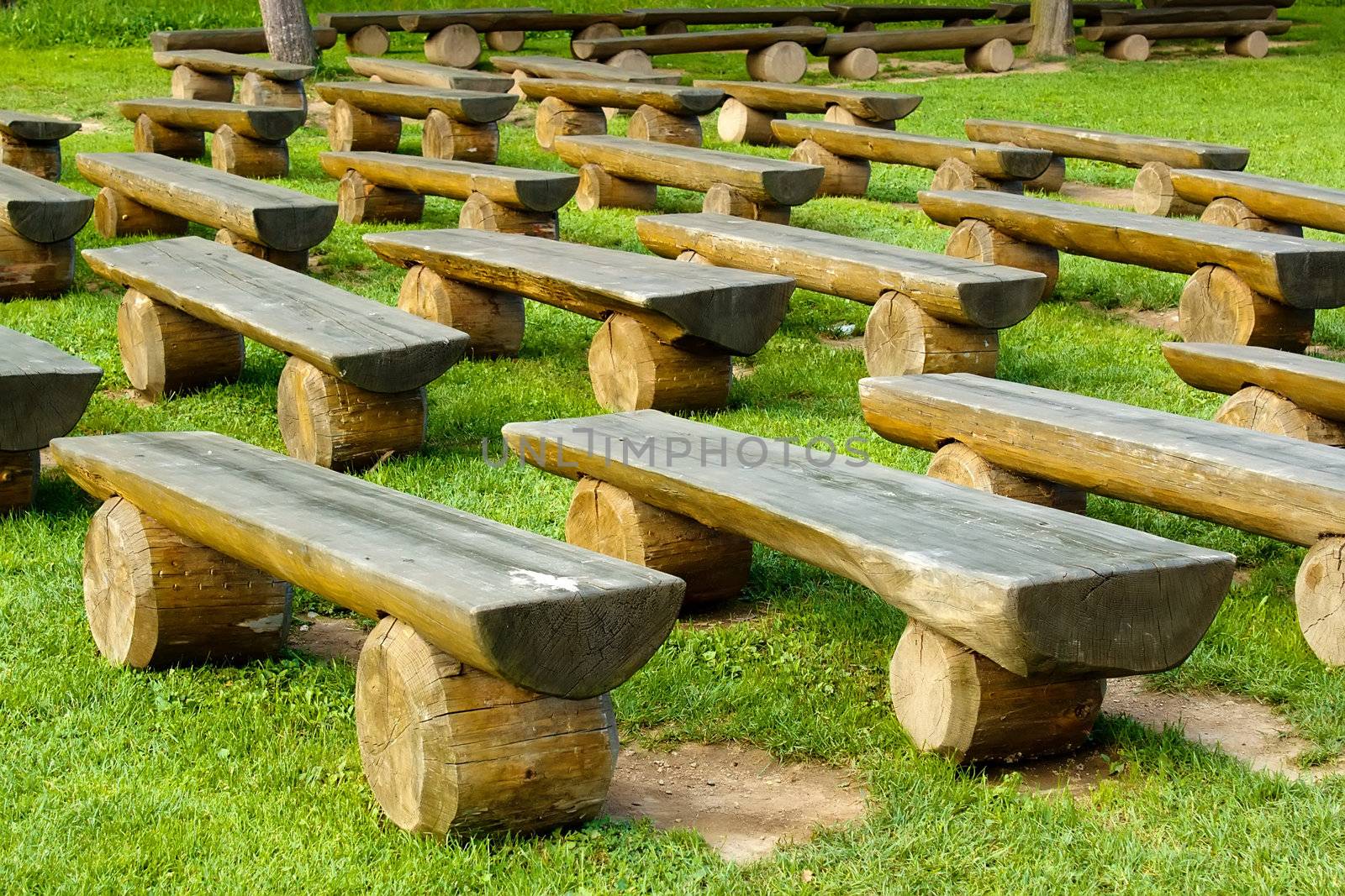 outdoor wood seating on green lawn by artush