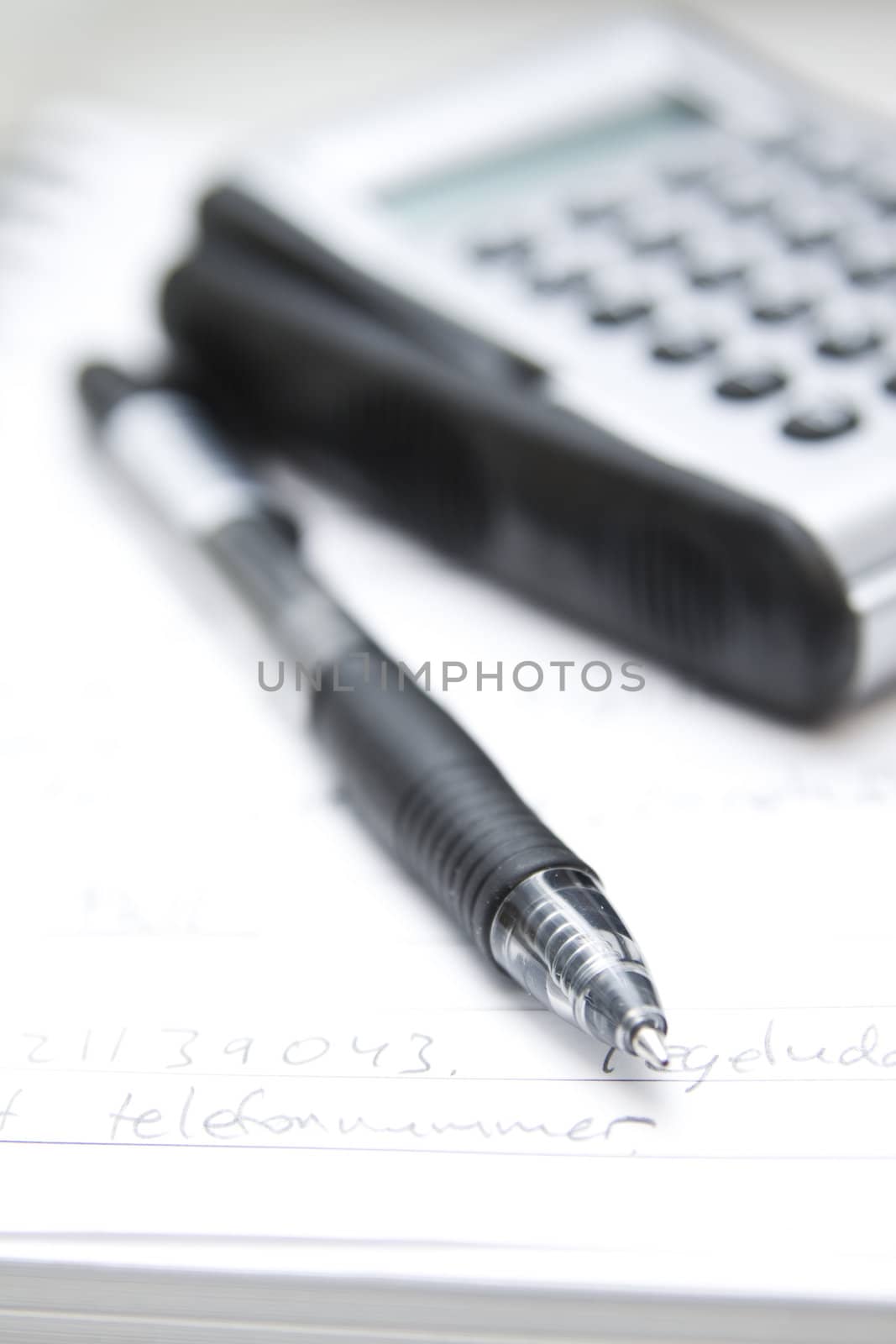 pen, calculator and agenda (selective focus)