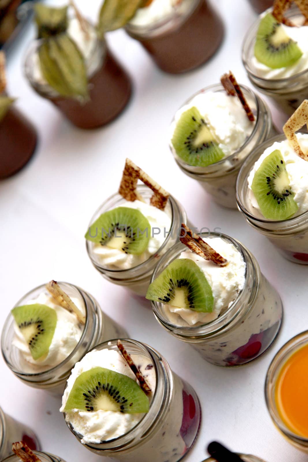 sweet dessert decorated with kiwi-served in the glass close-up
 