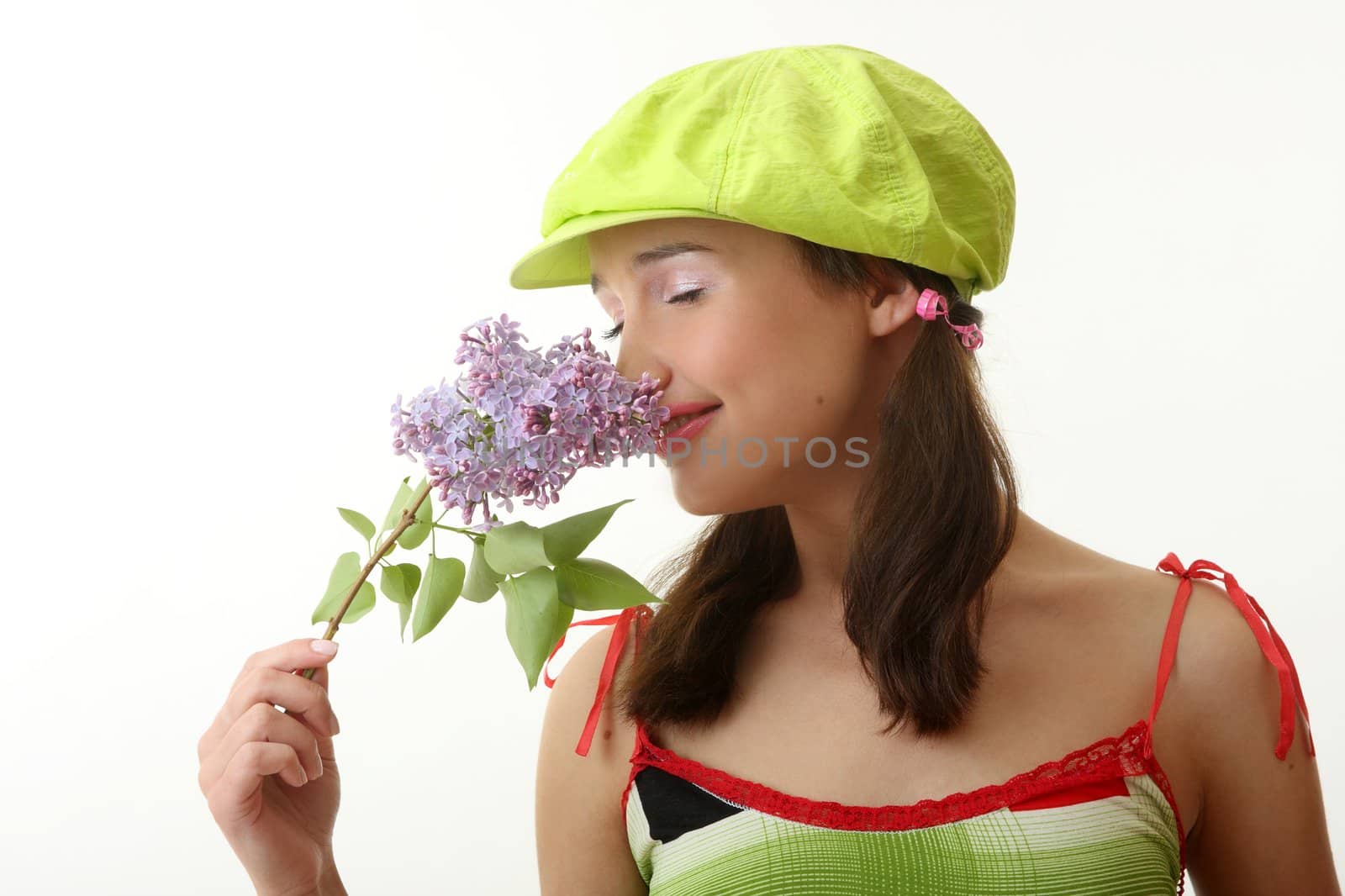 The girl in a green cap with a lilac bouquet