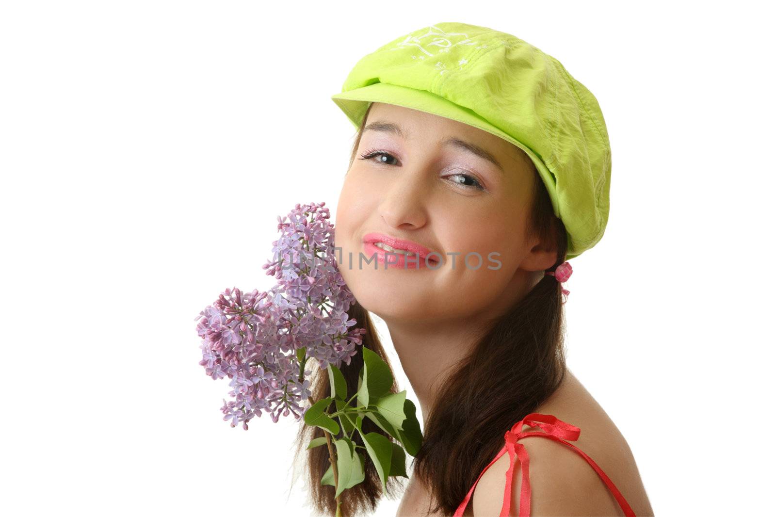 The girl in a green cap with a lilac bouquet