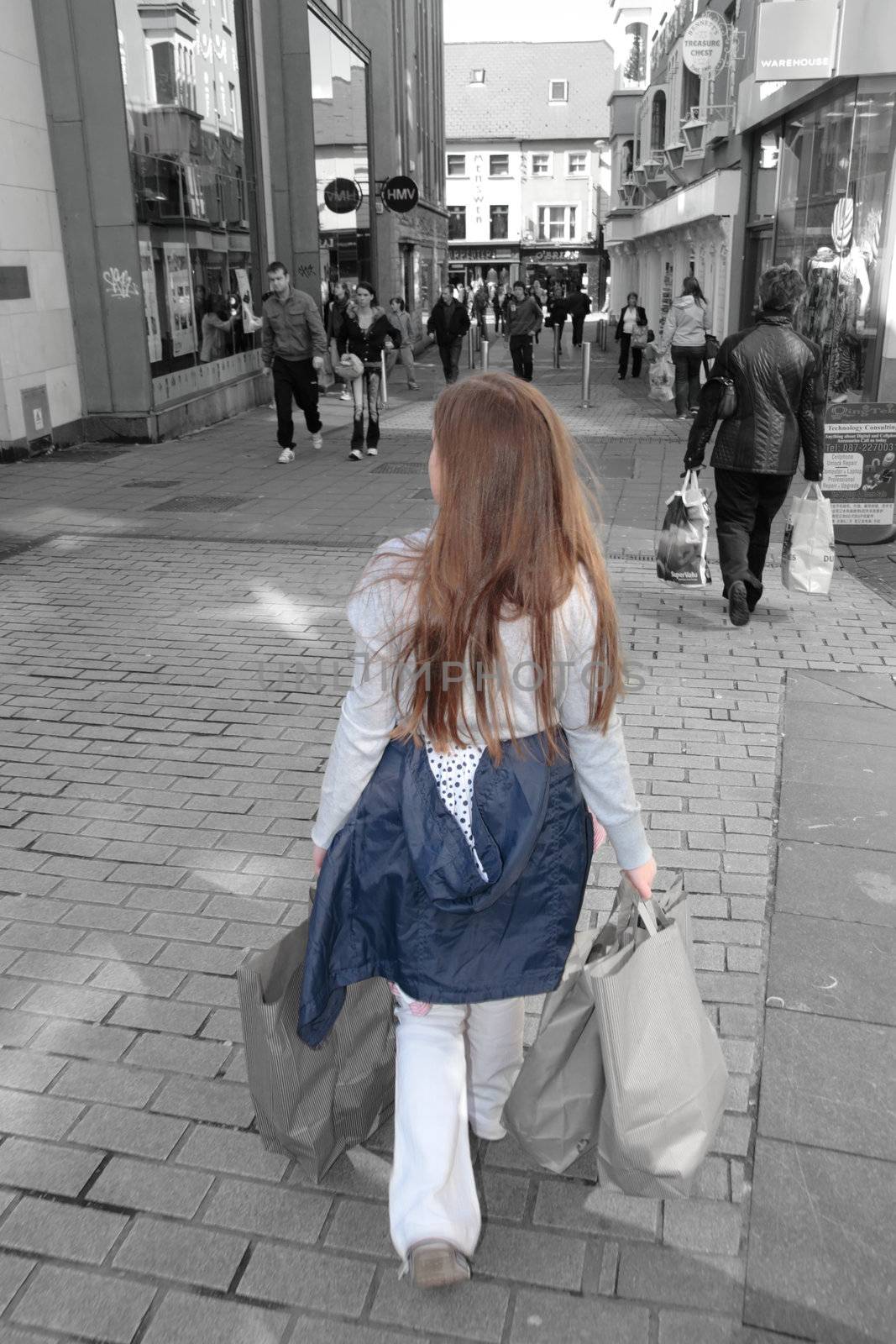 a young girl with shopping bags on a high street