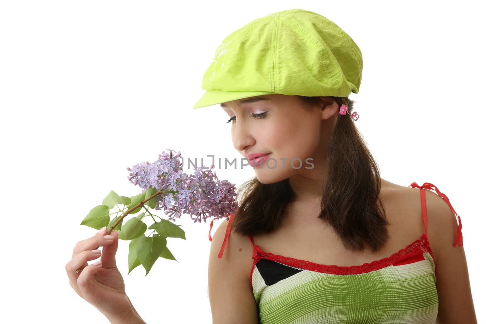 The girl in a green cap with a lilac bouquet