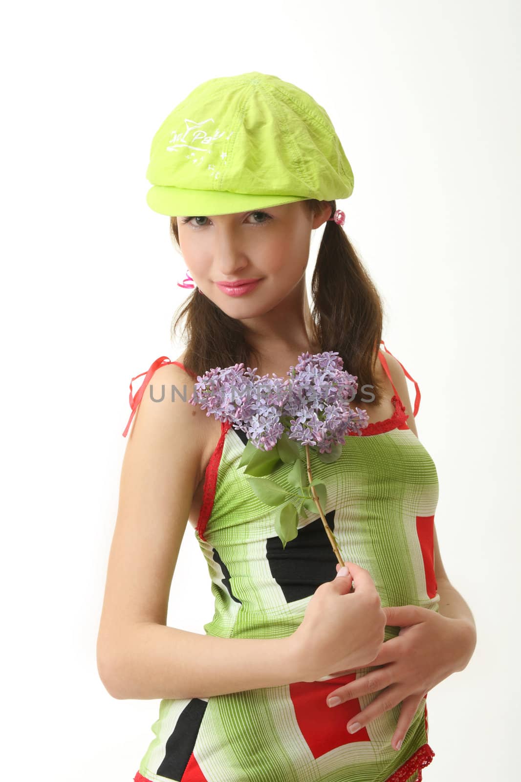 The girl in a green cap with a lilac bouquet