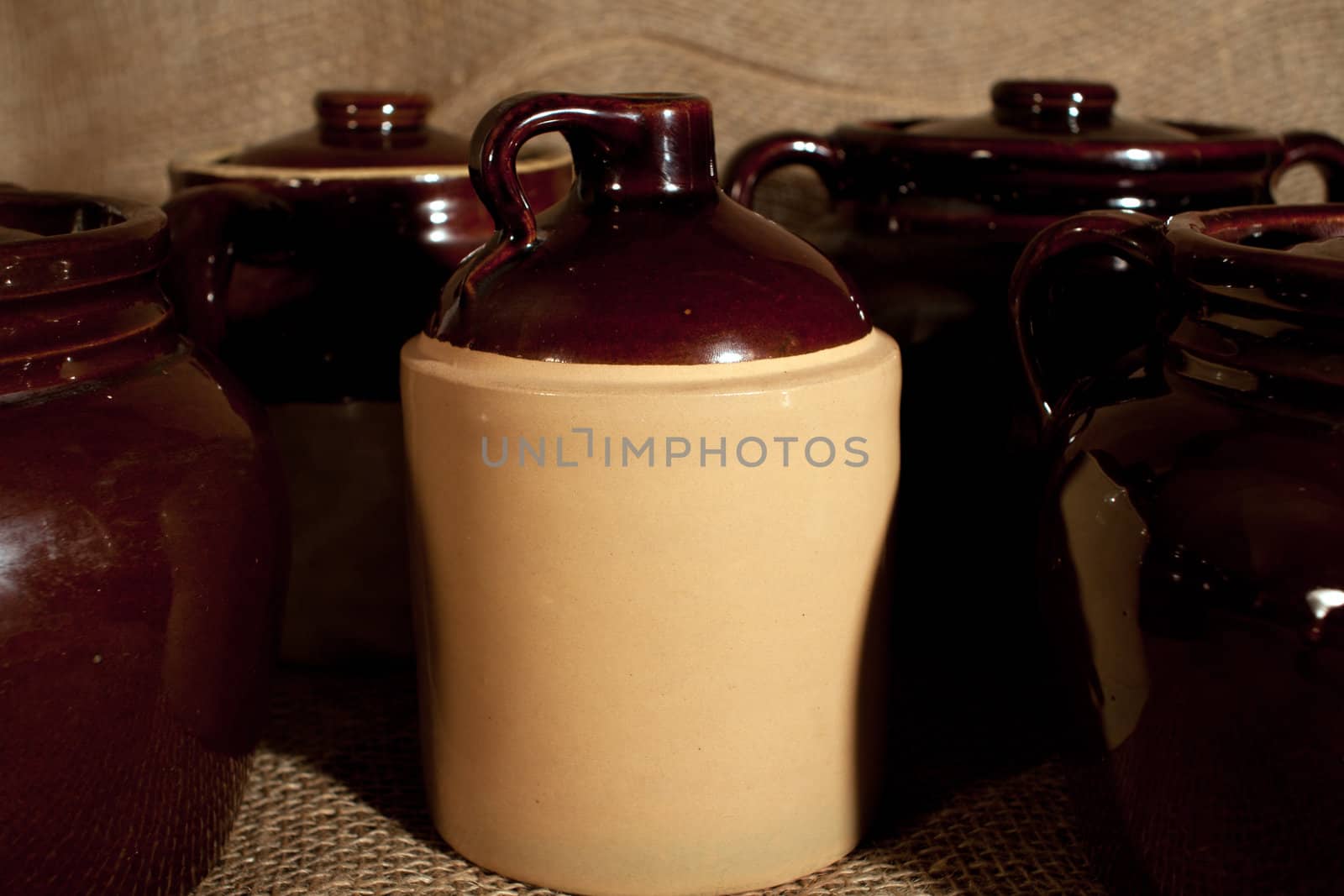 Some stoneware pottery on a burlap background