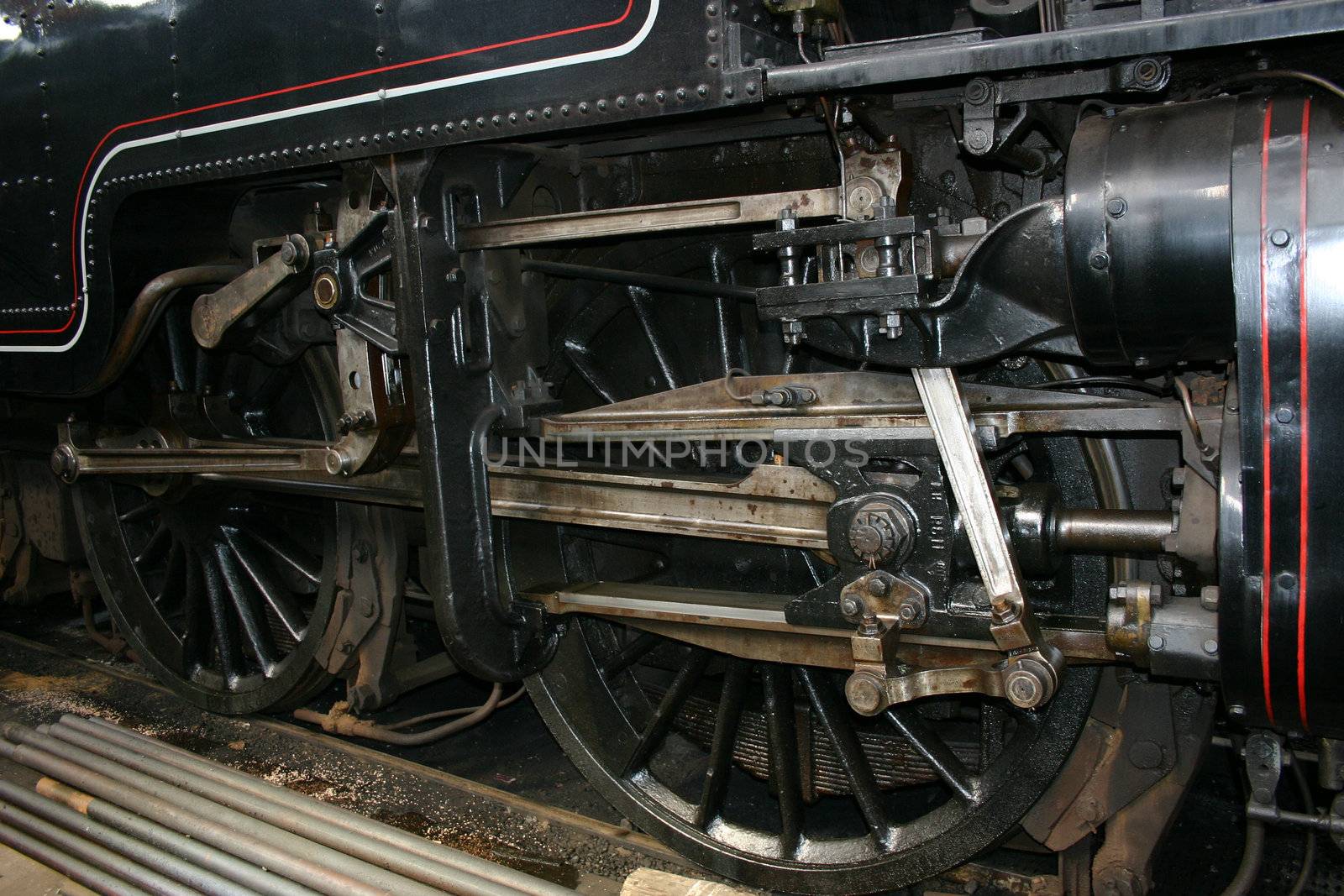 detail of the wheels and pistons of a steam train