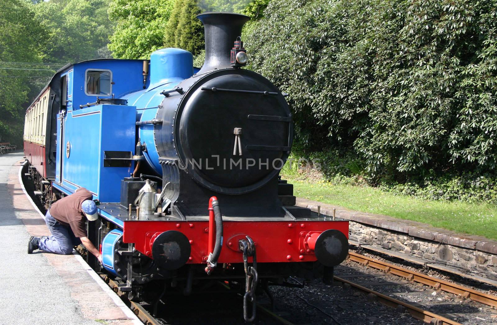 steam locomotive being checked by the driver