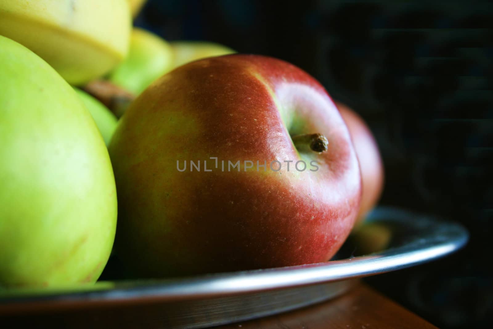 red and green apples focus on the front apple and taken with natural light,