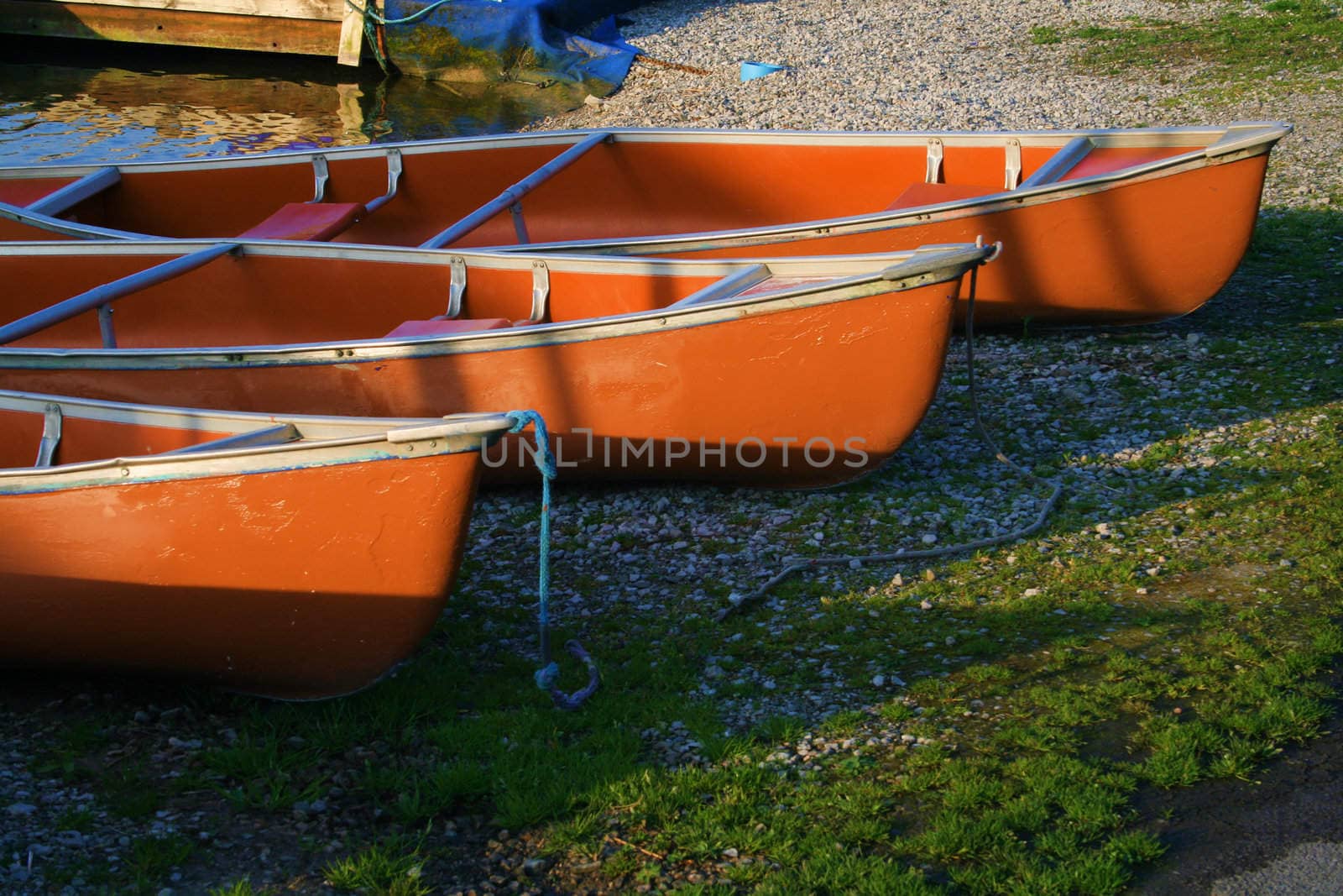 canoes on the river bank lit with the morning light