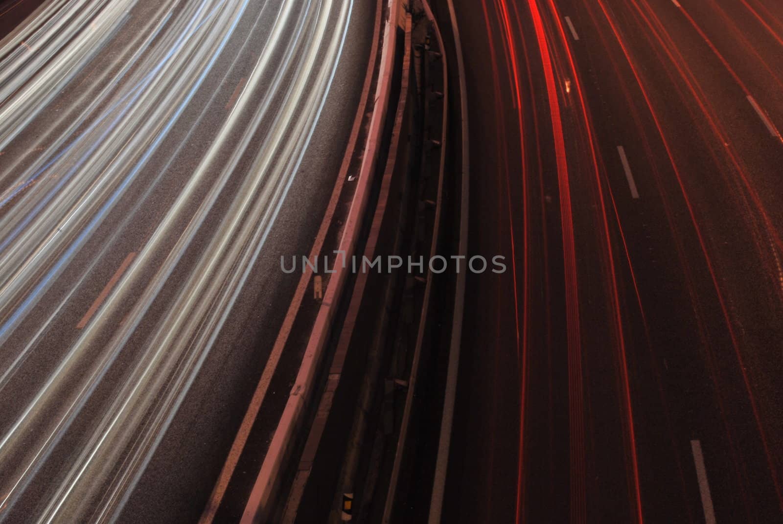 a night time shot of speeding traffic on a freeway