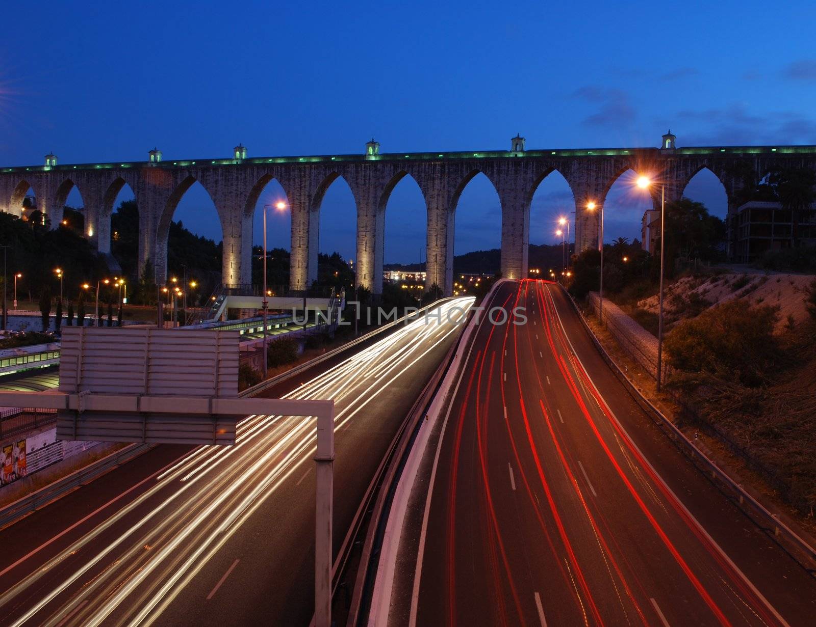 historic aqueduct in the city of Lisbon built in 18th century (car blur motion)