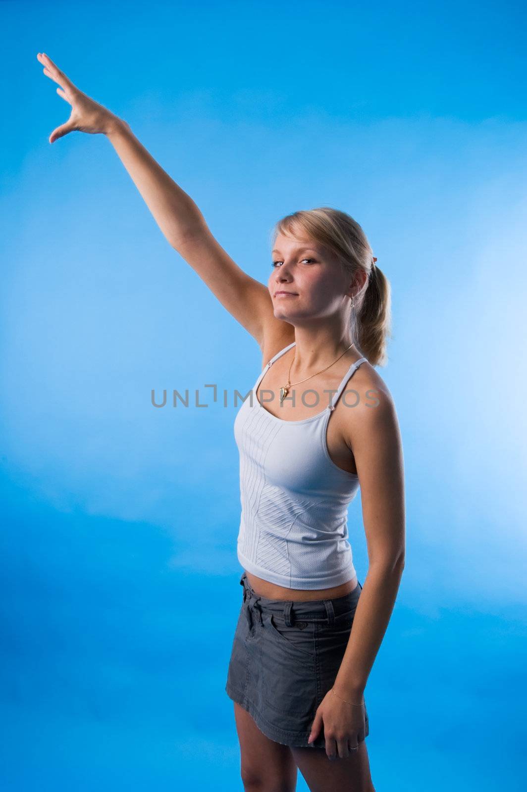 The girl in a white vest tries to reach the sky