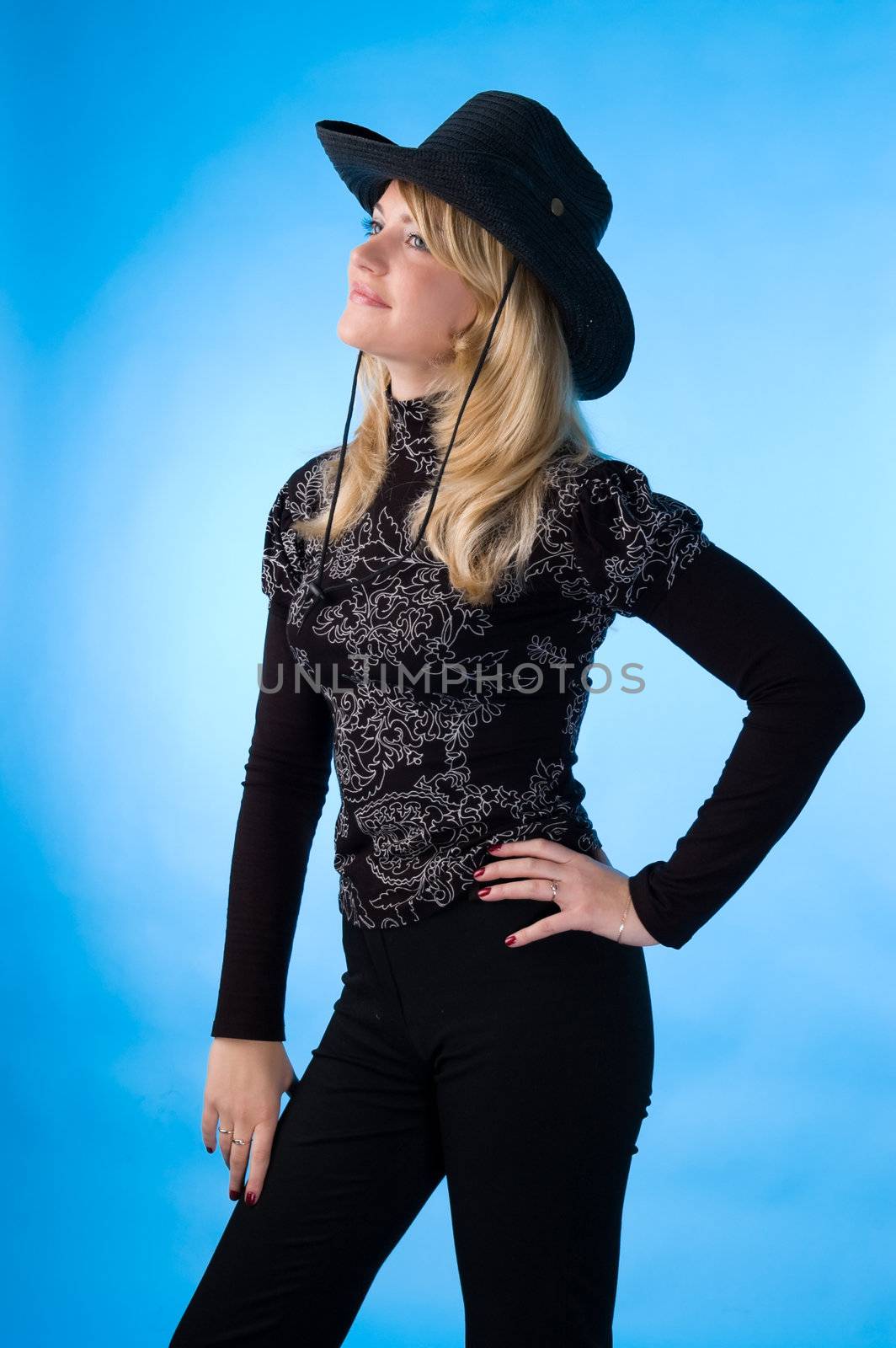 The beauty blonde in the studio, isolated on a blue background.