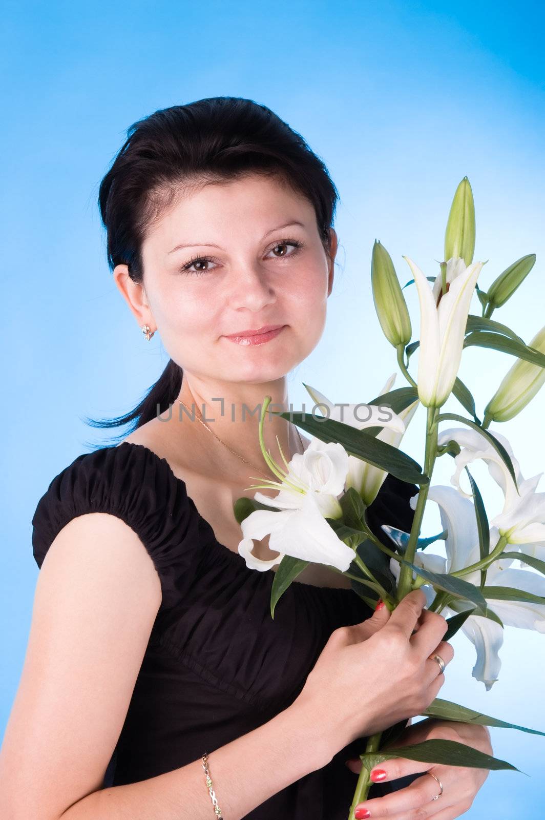 The attractive woman with a bouquet of lilies. by andyphoto