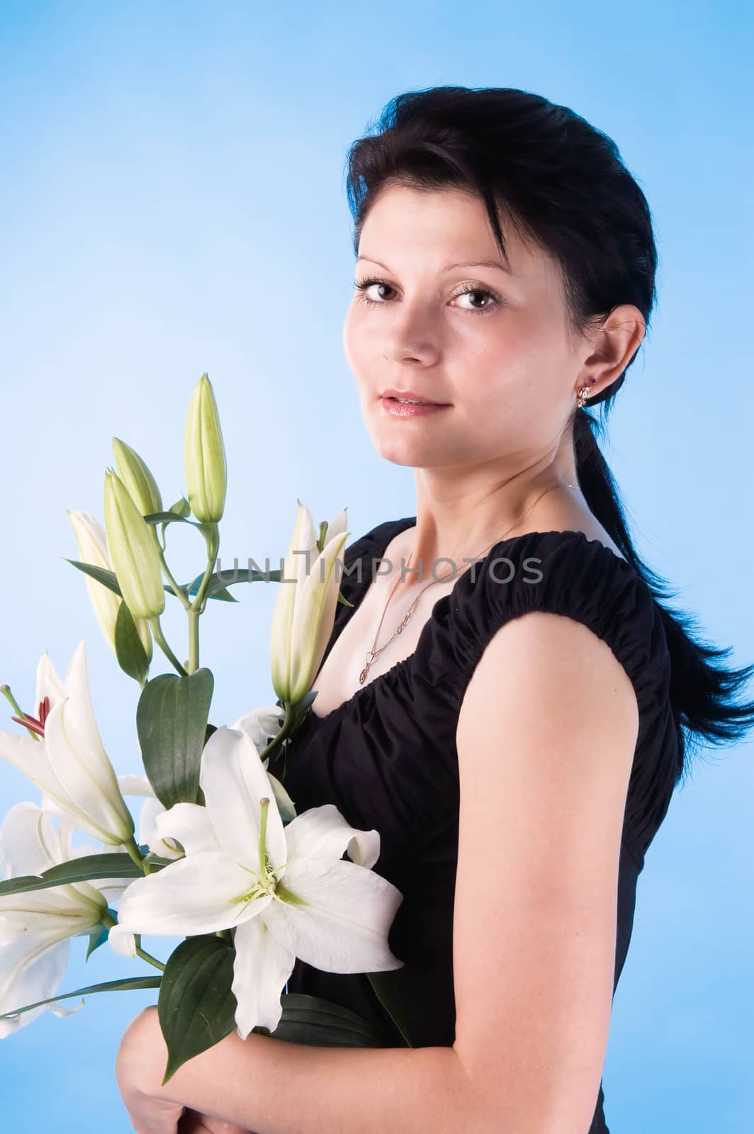 The attractive woman with a bouquet of lilies. by andyphoto