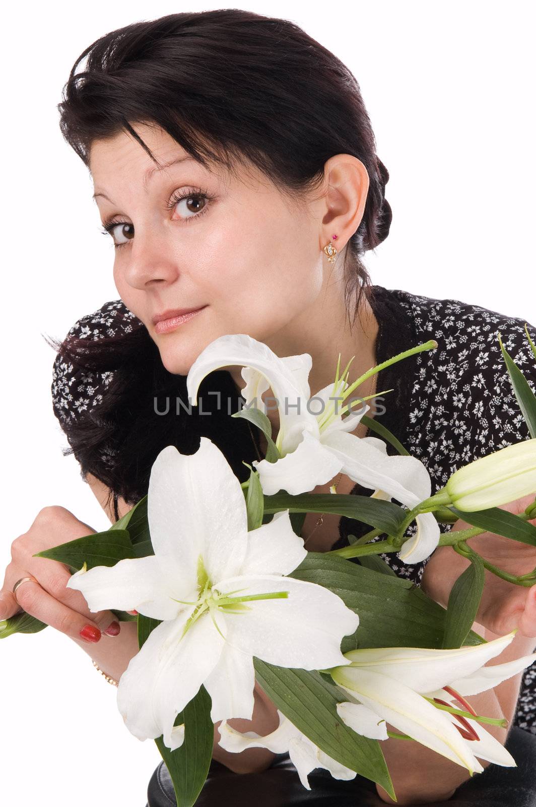 The attractive woman holds a bouquet of lilies in hands