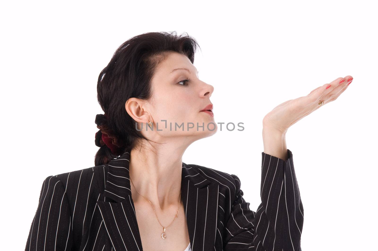 The girl in a business suit blows on a palm