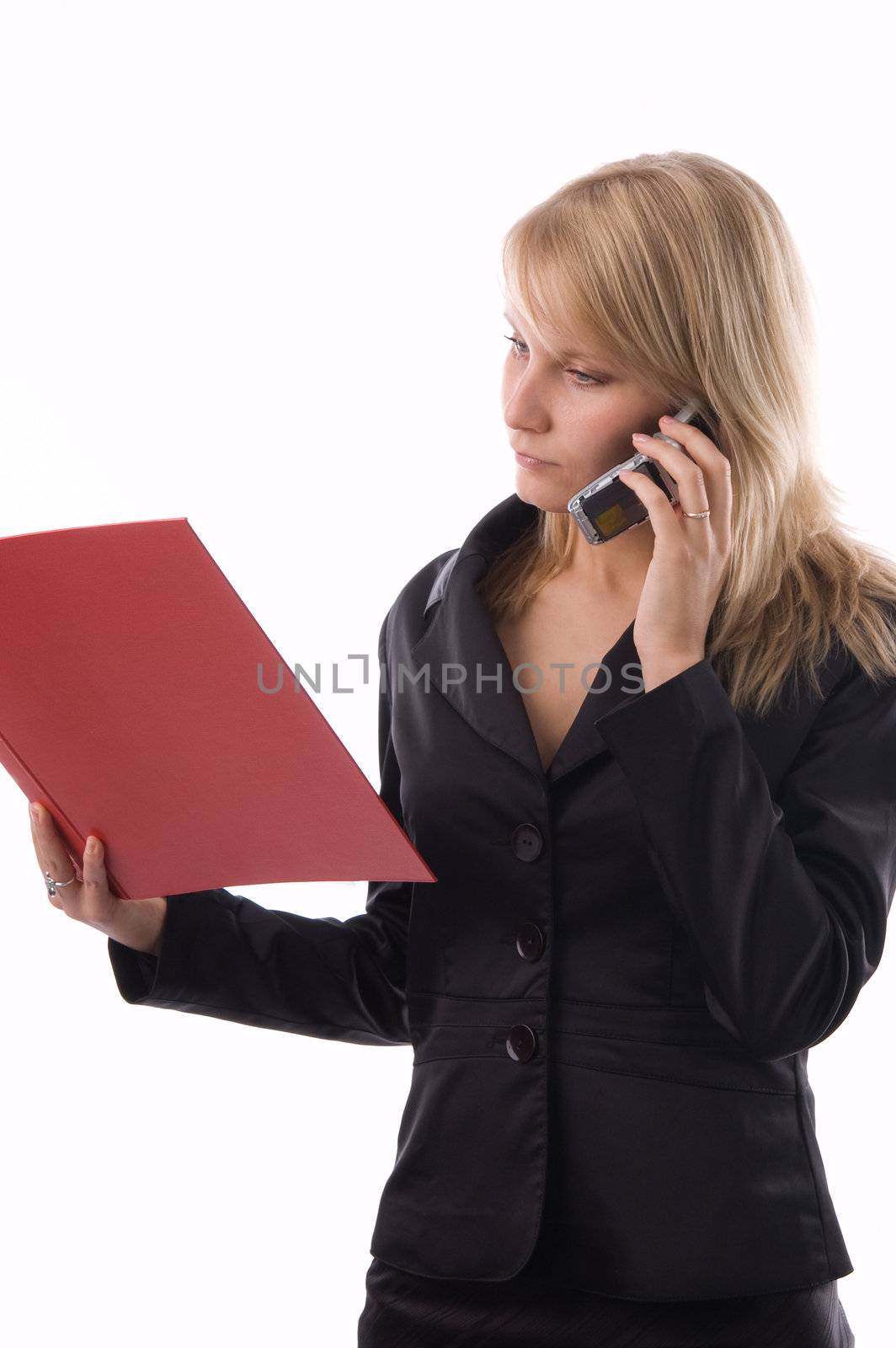 The businesswoman reads documents and speaks by phone.
