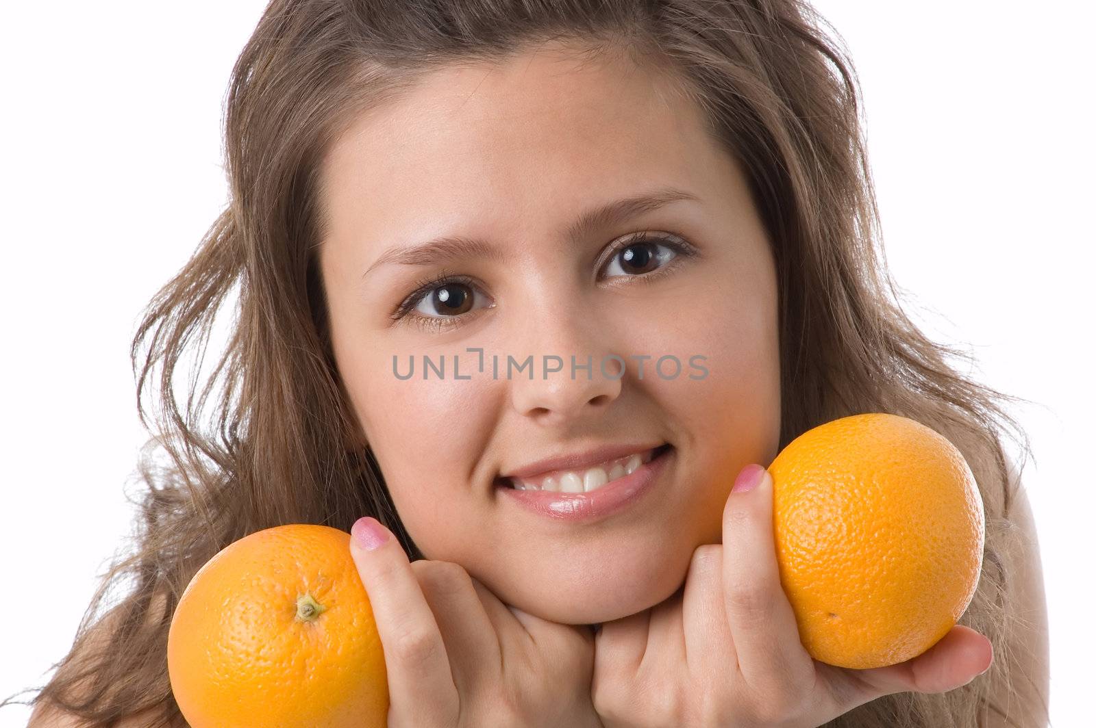 The brown-eyed girl on a white background holds oranges