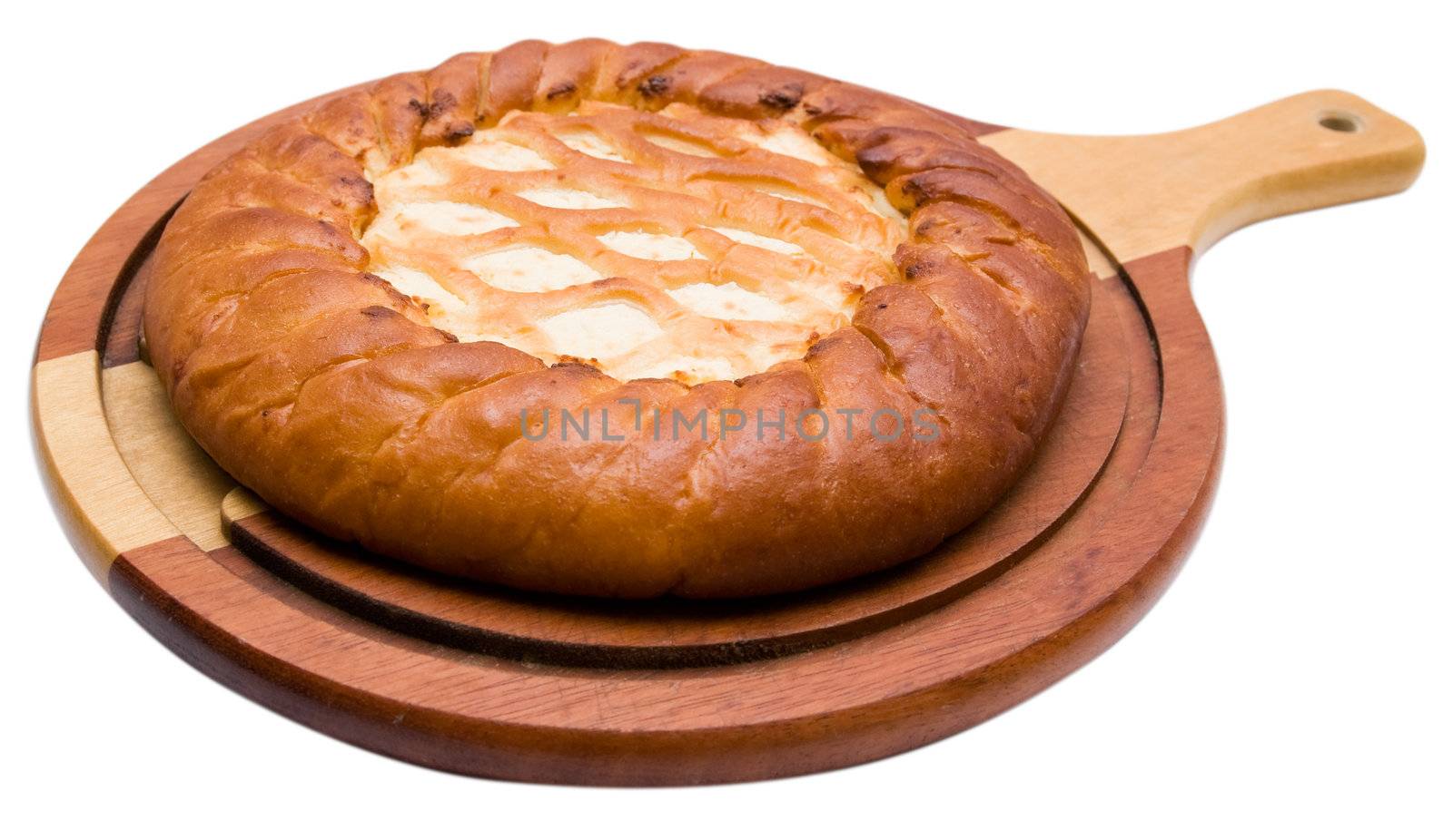 The celebratory pie lays on a board, isolated on a white background.