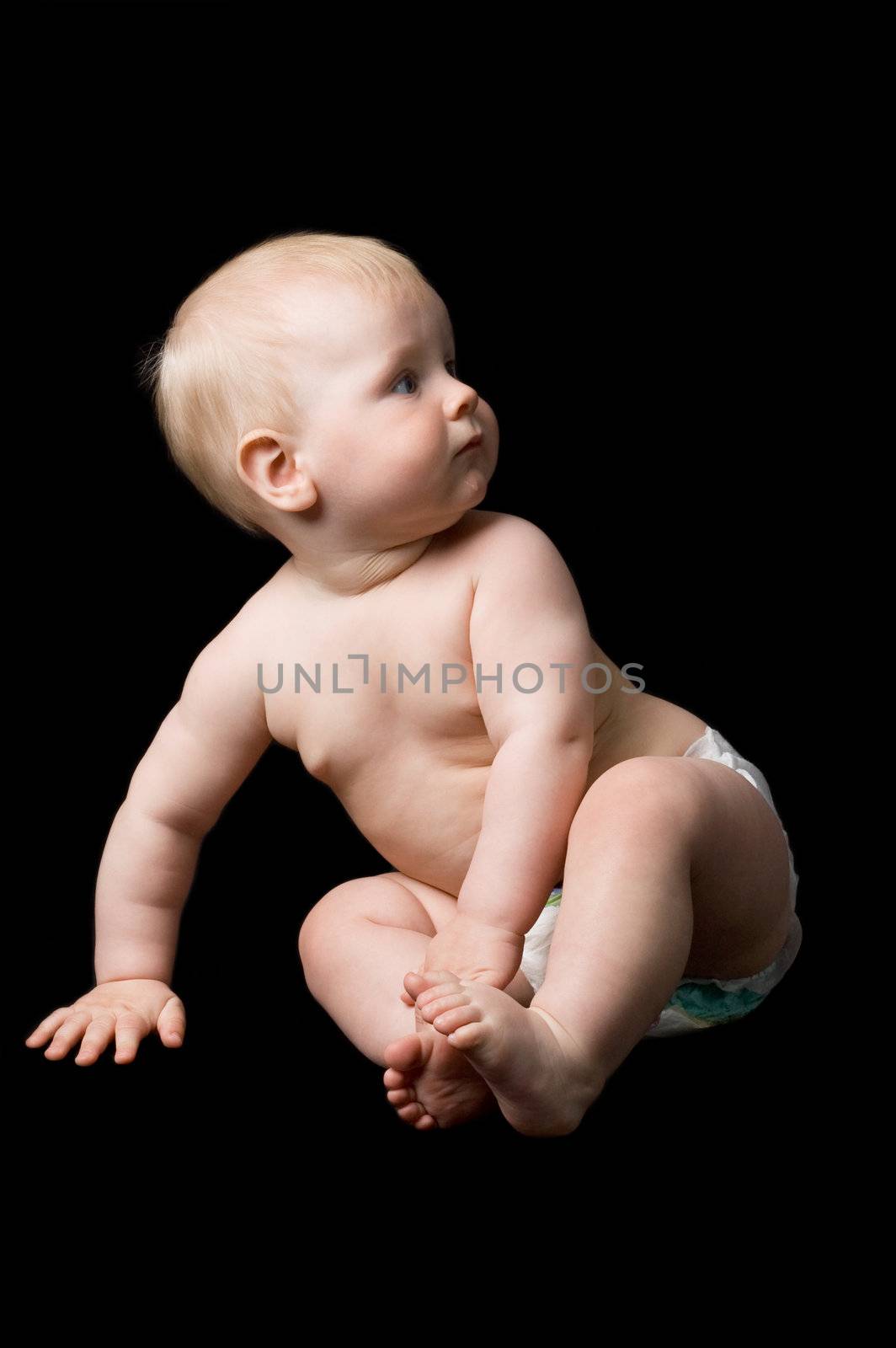 The small child in studio, on a black background