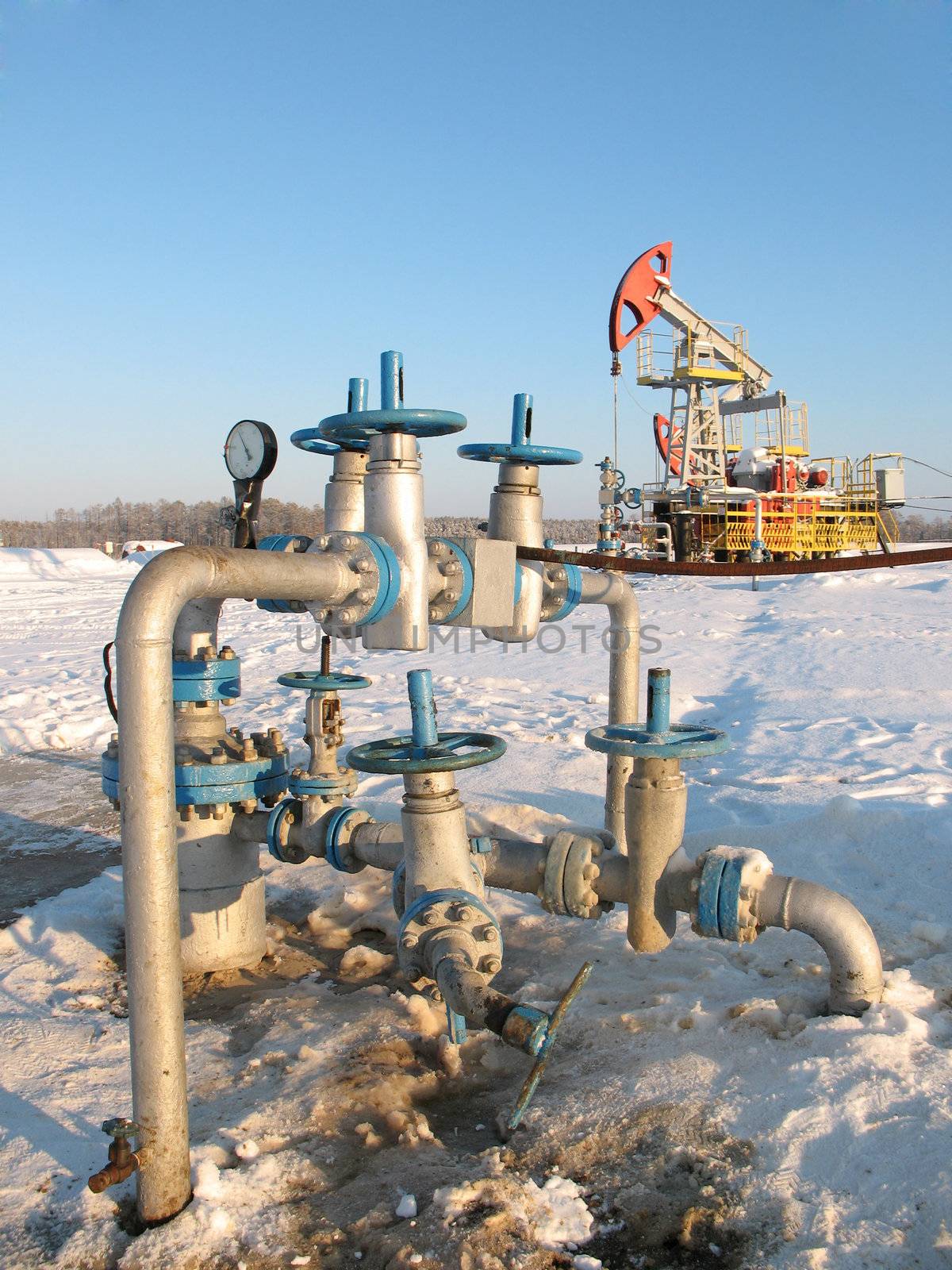 Oil pump jack in work. Oil industry in West Siberia. Siberian frost in sunny day.